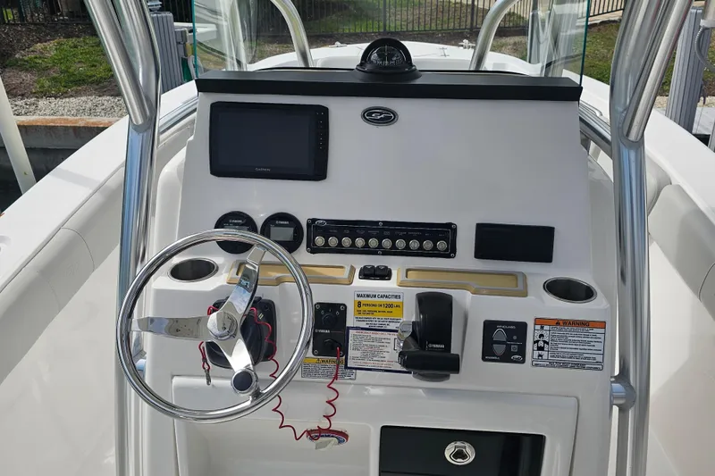 Slide: The Image of 2020 Sea Fox 228 Commander boat console with steering wheel and navigation controls. - 6