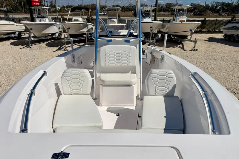 Slide: The Image of 2023 Aquasport 2200 Center Console boat with white seating and sleek design. - 10