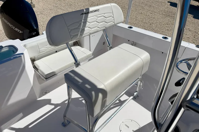 Slide: The Image of 2023 Aquasport 2200 Center Console boat interior with seating and Mercury engine. - 15