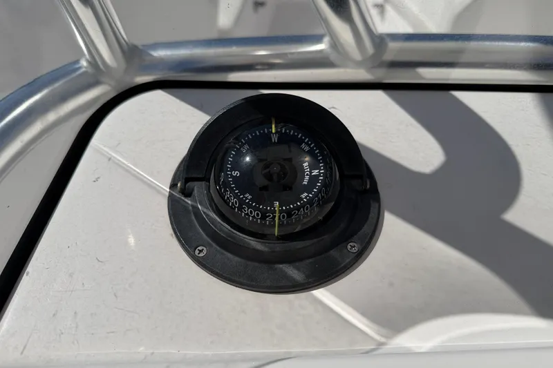 Slide: The Image of Compass on 2023 Aquasport 2200 Center Console boat dashboard. - 18