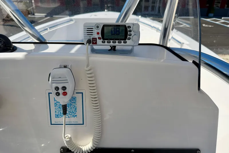Slide: The Image of 2023 Aquasport 2200 Center Console dashboard with radio and QR code. - 22