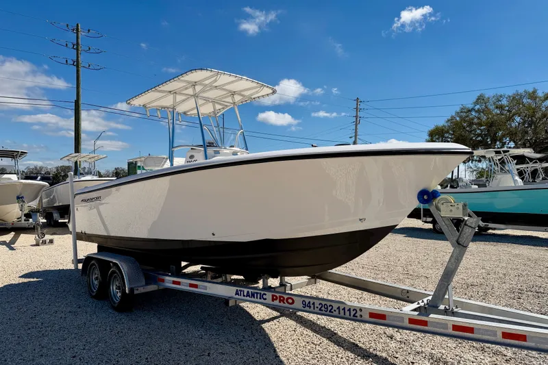 Slide: The Image of 2023 Aquasport 2200 Center Console boat on trailer under clear blue sky. - 3