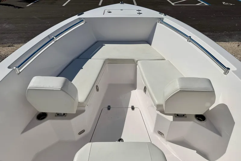 Slide: The Image of 2023 Aquasport 2200 Center Console boat interior with white cushioned seating. - 8