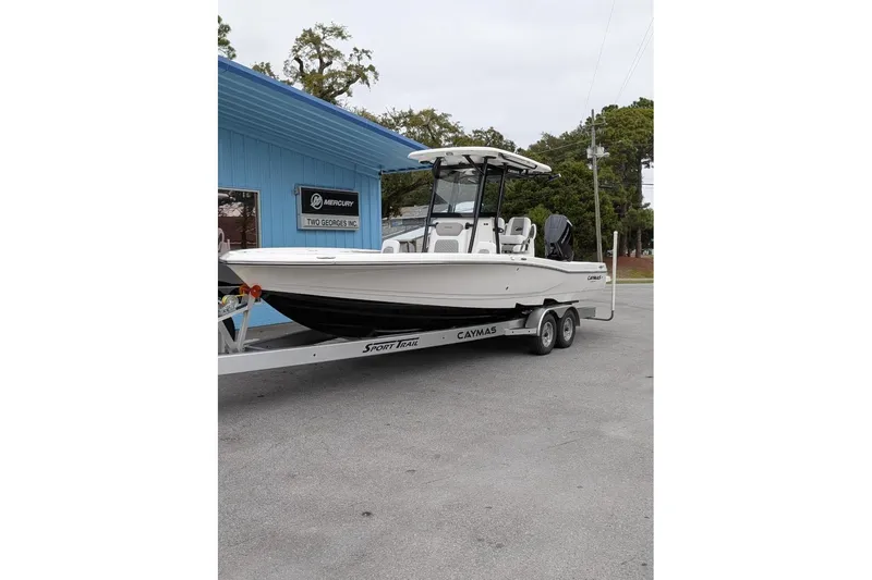 Slide: The Image of 2026 Caymas 28 HB boat on trailer outside dealership, featuring sleek design and modern features. - 4