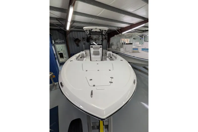 Slide: The Image of 2026 Caymas 28 HB boat in showroom, sleek design, white exterior, modern features. - 6