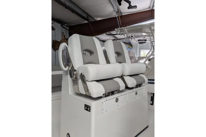 Slide: The Image of 2026 Caymas 28 HB boat interior with modern white seating and storage compartments. - 8