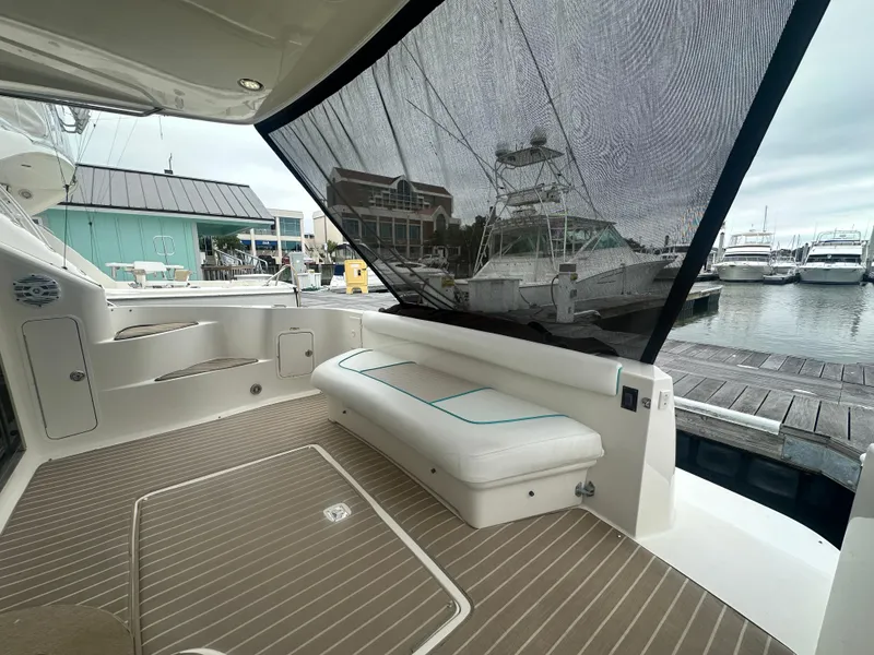 Slide: The Image of 1997 Sea Ray 400 Sedan Bridge yacht with spacious deck and marina view. - 11
