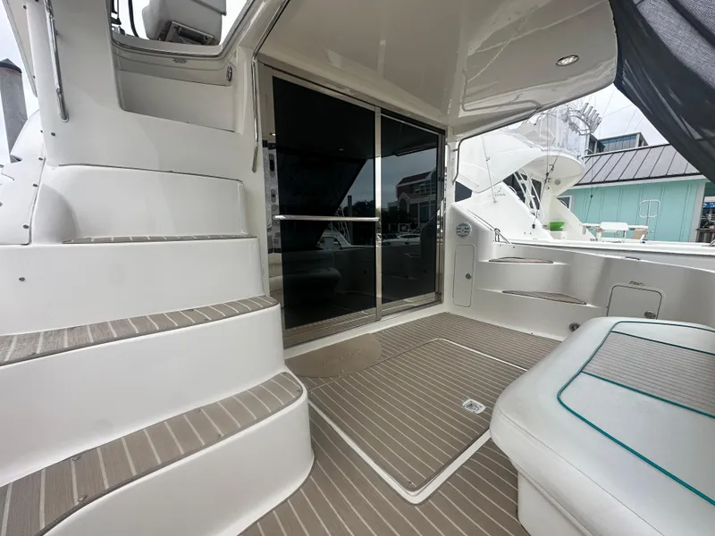 Slide: The Image of 1997 Sea Ray 400 Sedan Bridge yacht interior with stairs and seating area. - 12