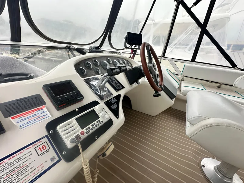 Slide: The Image of 1997 Sea Ray 400 Sedan Bridge helm with controls and seating. - 14