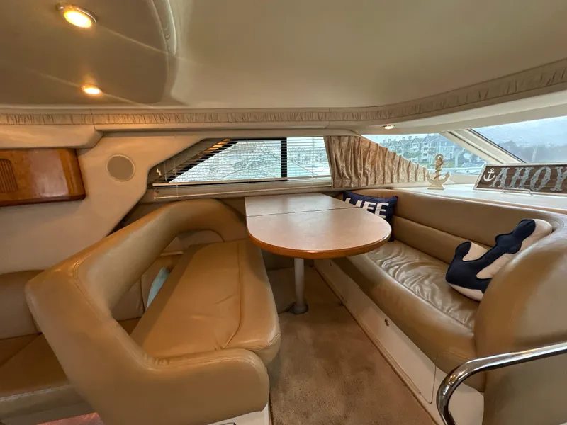 Slide: The Image of Interior of 1997 Sea Ray 400 Sedan Bridge with leather seating and dining table. - 28