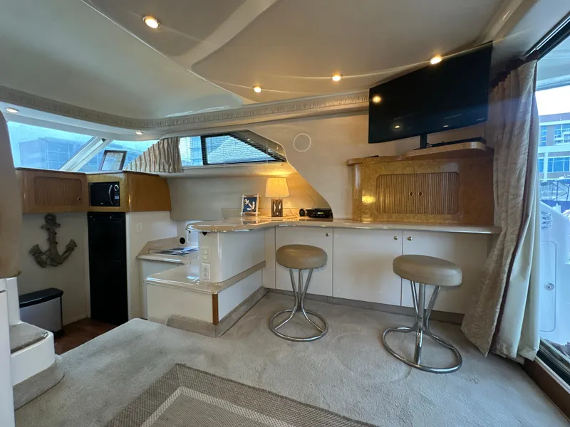 Slide: The Image of Interior of a 1997 Sea Ray 400 Sedan Bridge yacht with modern furnishings. - 29