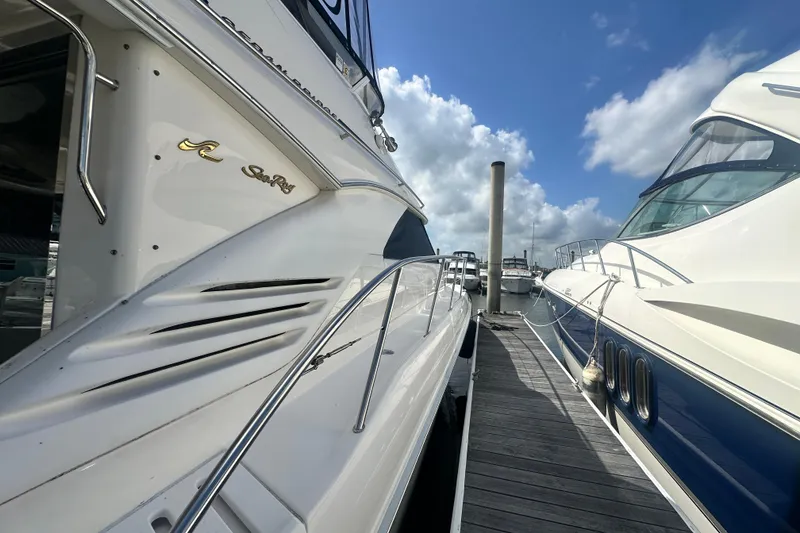 Slide: The Image of 1997 Sea Ray 400 Sedan Bridge yacht docked under a bright blue sky. - 3