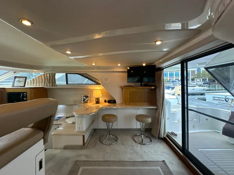 Slide: The Image of Interior of 1997 Sea Ray 400 Sedan Bridge yacht with modern furnishings and large windows. - 30