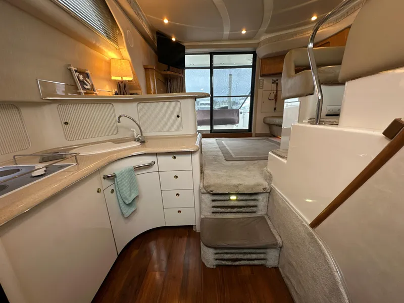 Slide: The Image of Luxurious interior of 1997 Sea Ray 400 Sedan Bridge yacht with modern kitchen and cozy seating. - 35
