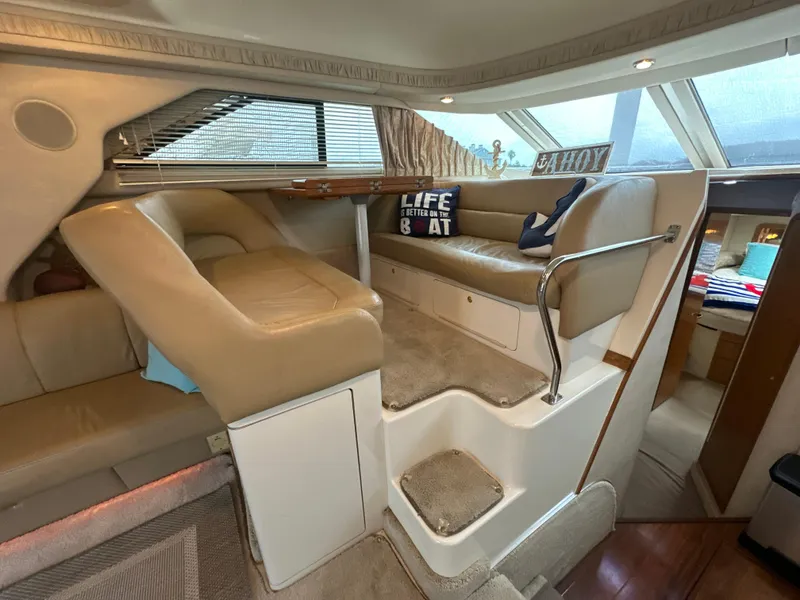 Slide: The Image of Interior of 1997 Sea Ray 400 Sedan Bridge with beige seating and nautical decor. - 36
