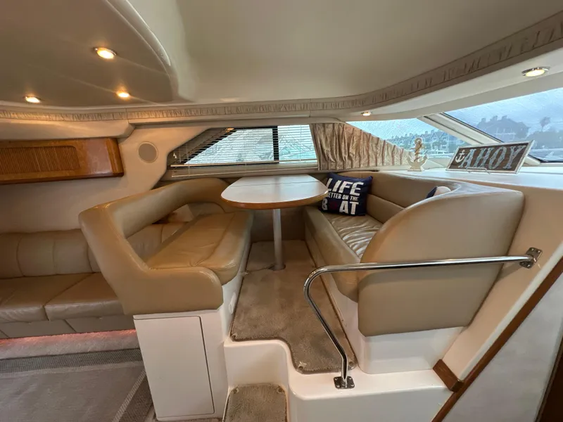Slide: The Image of 1997 Sea Ray 400 Sedan Bridge interior with beige seating and dining area. - 37