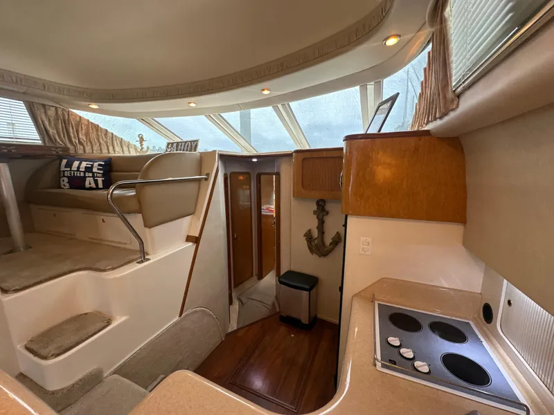 Slide: The Image of Interior of 1997 Sea Ray 400 Sedan Bridge yacht with kitchen and stairs. - 39