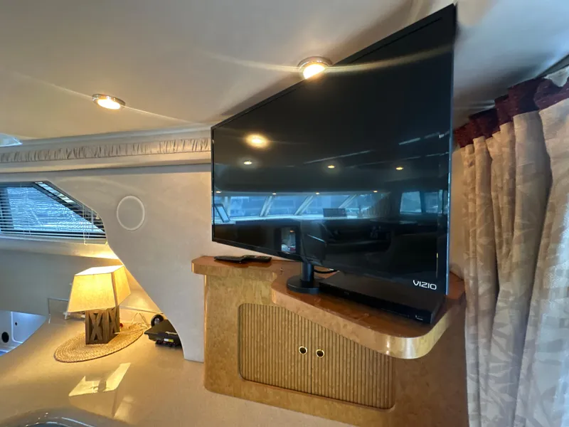 Slide: The Image of Interior of 1997 Sea Ray 400 Sedan Bridge with TV and lamp. - 40