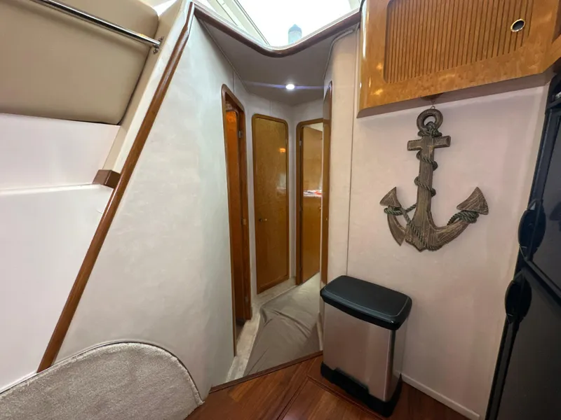 Slide: The Image of Interior of 1997 Sea Ray 400 Sedan Bridge with anchor decor and wooden accents. - 41