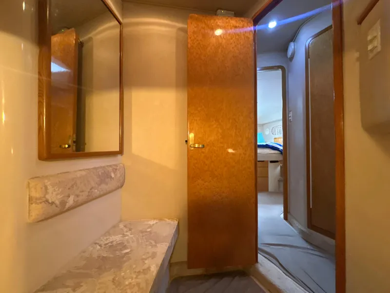 Slide: The Image of Interior of 1997 Sea Ray 400 Sedan Bridge with wooden doors and mirror. - 43