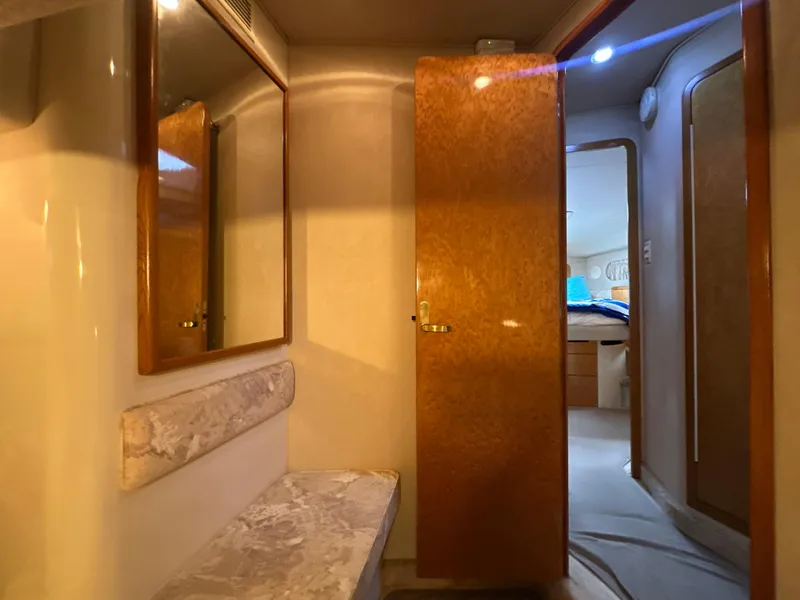 Slide: The Image of Interior of 1997 Sea Ray 400 Sedan Bridge with wooden door and mirror. - 44