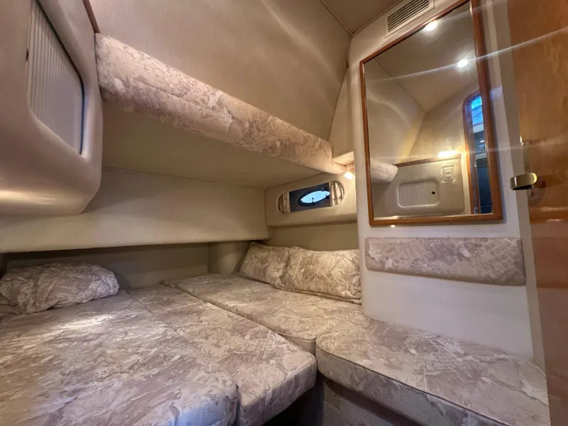 Slide: The Image of Interior of 1997 Sea Ray 400 Sedan Bridge with cozy beds. - 49