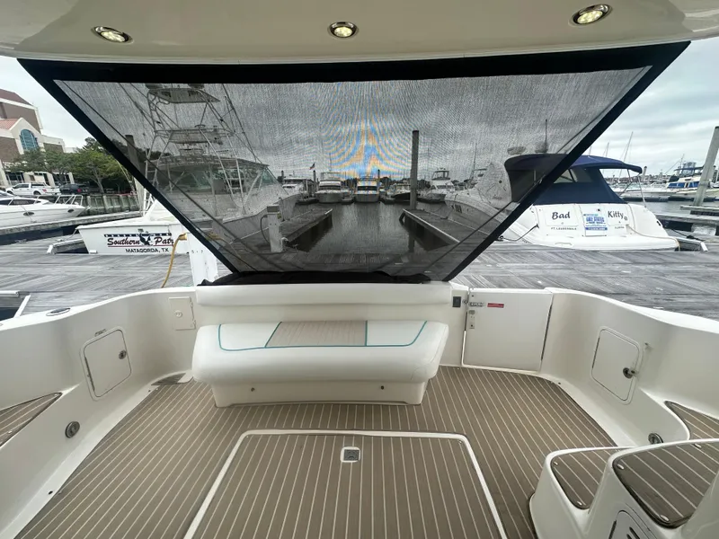 Slide: The Image of 1997 Sea Ray 400 Sedan Bridge yacht interior with seating and marina view. - 7