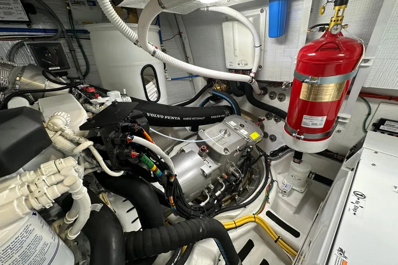 Slide: The Image of Engine room of 2025 Sabre 48 Salon Express with Volvo Penta components and fire extinguisher. - 11