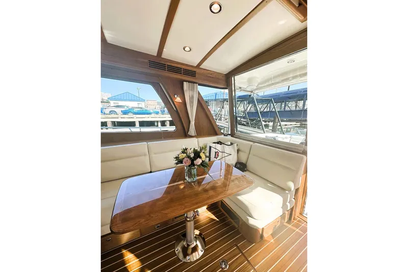 Slide: The Image of Interior of 2025 Sabre 48 Salon Express yacht with elegant seating and wooden table. - 19