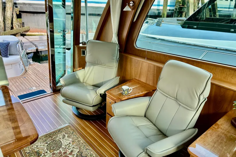 Slide: The Image of Luxurious interior of 2025 Sabre 48 Salon Express yacht with leather chairs and wooden accents. - 2
