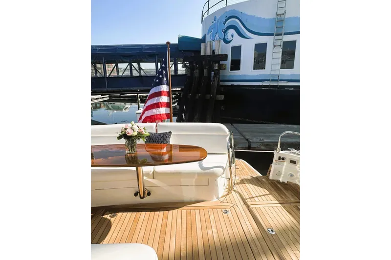 Slide: The Image of 2025 Sabre 48 Salon Express yacht deck with American flag and floral centerpiece. - 21
