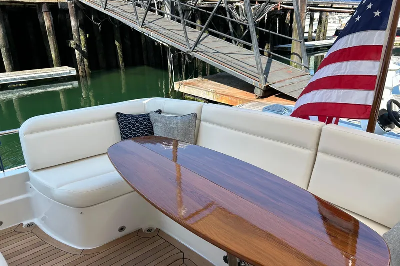 Slide: The Image of Luxurious seating area on 2025 Sabre 48 Salon Express yacht with American flag. - 3
