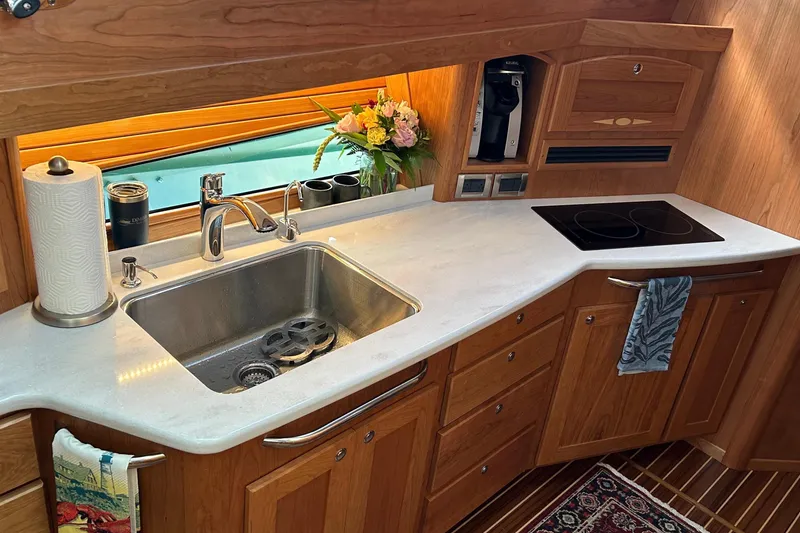 Slide: The Image of Luxurious kitchen interior of 2025 Sabre 48 Salon Express yacht with wooden cabinetry. - 8