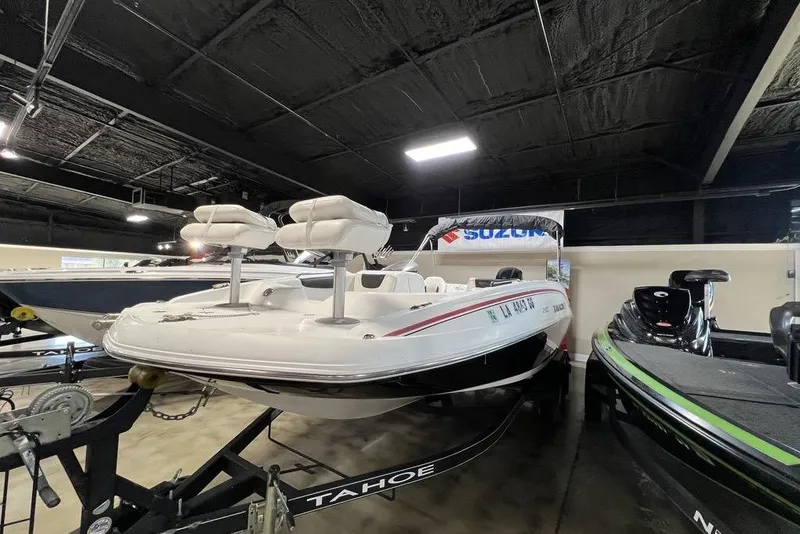 Slide: The Image of 2017 Tahoe 2150 boat displayed indoors on a trailer. - 10