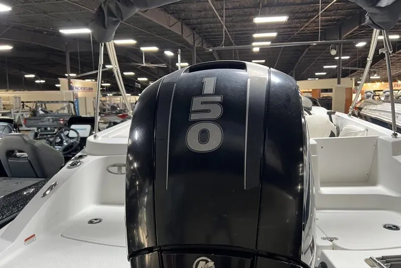 Slide: The Image of 2017 Tahoe 2150 boat with 150 HP engine in showroom setting. - 2