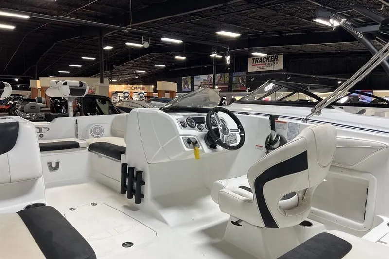 Slide: The Image of 2017 Tahoe 2150 boat interior with steering wheel and seating in showroom. - 5