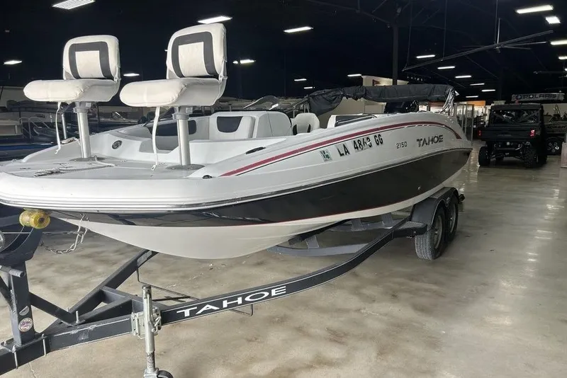 Slide: The Image of 2017 Tahoe 2150 boat on trailer in indoor showroom setting. - 6