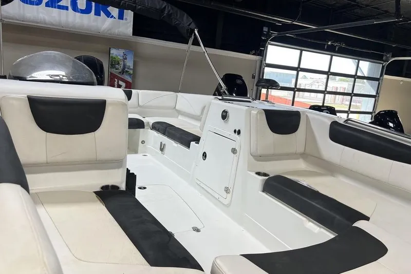 Slide: The Image of 2017 Tahoe 2150 boat interior with white and black seating in showroom. - 7