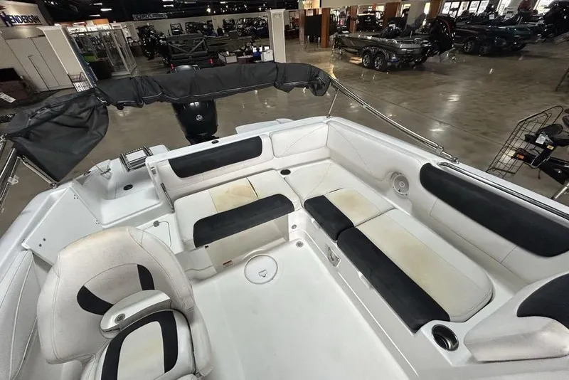 Slide: The Image of 2017 Tahoe 2150 boat interior with white and black seating in showroom. - 9