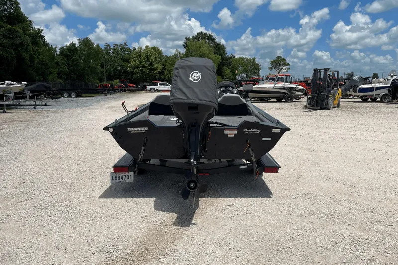 Slide: The Image of 2016 Tracker Pro Team 190 TX boat in a gravel lot under a cloudy sky. - 4