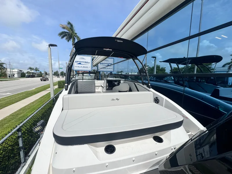 Slide: The Image of The image shows a 2026 Sea Ray SPX 210 Outboard boat parked beside a building. - 11