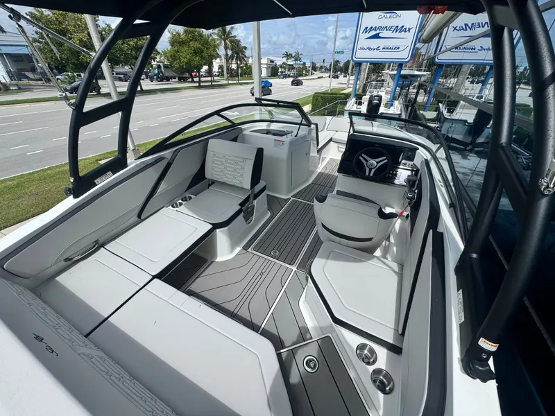 Slide: The Image of The image shows the interior of a Sea Ray SPX 210 Outboard boat with modern seating and helm. - 13