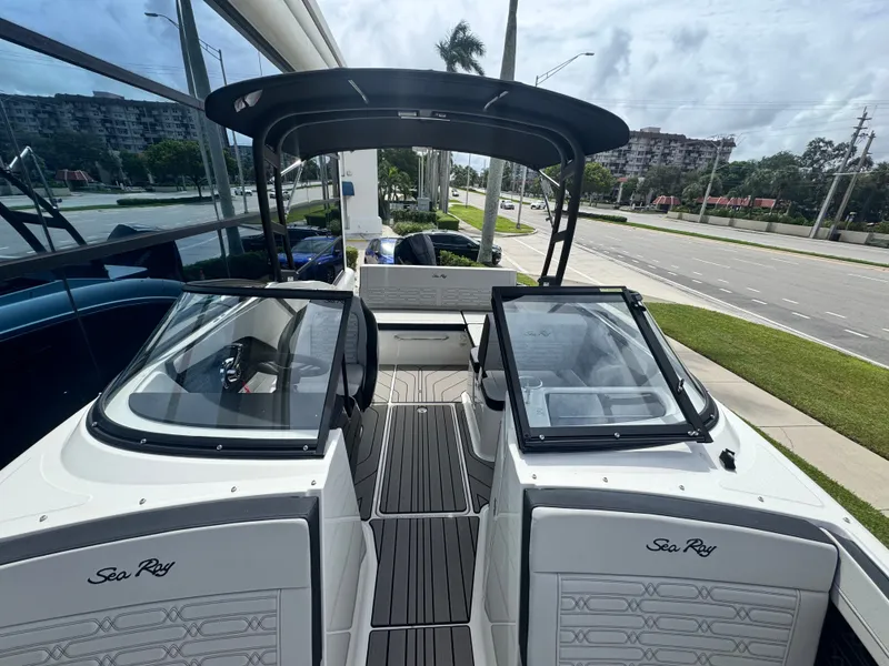 Slide: The Image of The image shows a Sea Ray SPX 210 Outboard boat with a modern design and spacious deck. - 17
