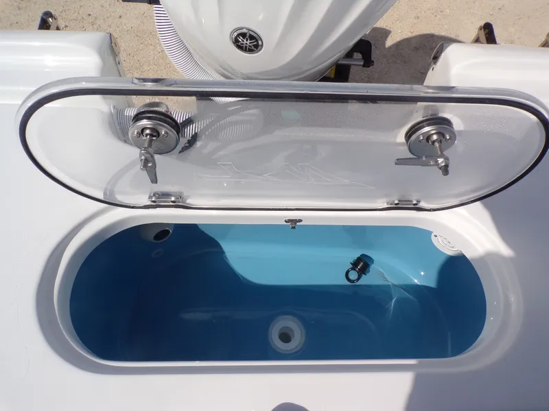 Slide: The Image of Tidewater 2500 Carolina Bay 2026, open storage compartment with blue interior. - 33