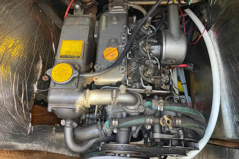 Slide: The Image of Engine of a 1994 Hunter 33.5 sailboat, showcasing mechanical components and hoses. - 8