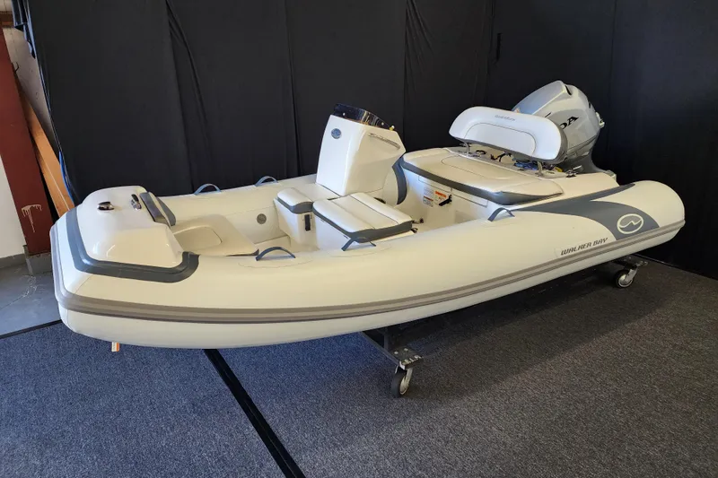 Slide: The Image of 2026 Walker Bay Generation 12 LTE inflatable boat on display indoors. - 0
