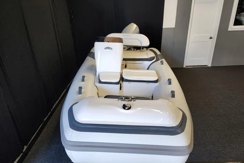 Slide: The Image of 2026 Walker Bay Generation 12 LTE inflatable boat in showroom, featuring sleek design and seating. - 1