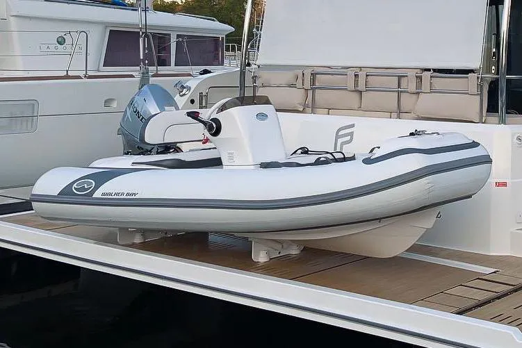 Slide: The Image of Manufacturer Provided Image: Walker Bay Generation 12 LTE 2025 inflatable boat docked, featuring sleek design and modern outboard motor. - 4