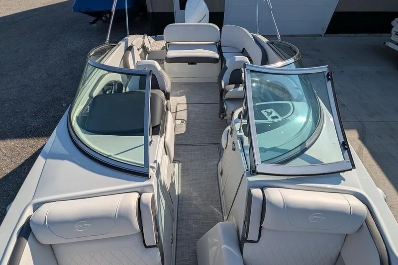 Slide: The Image of 2024 Crownline Eclipse E240 XS boat interior with seating and open windshield. - 18