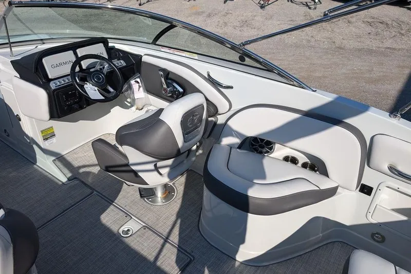 Slide: The Image of 2024 Crownline Eclipse E240 XS boat interior with steering wheel and seating area. - 20